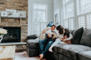 residential air purifier system showing happy family on couch with safe air quality